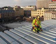 scan survey staff member working on a roof of a building in Oslo city centre